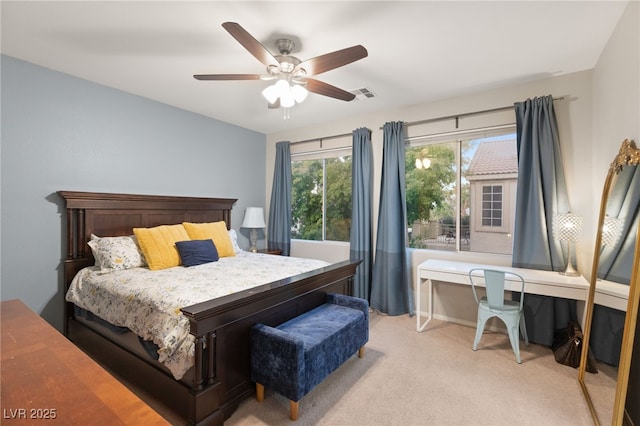 bedroom featuring a ceiling fan, light carpet, and visible vents
