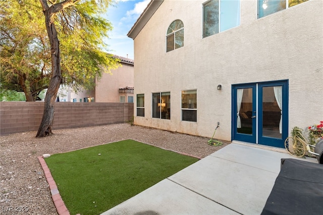 back of property featuring stucco siding, a patio area, and a fenced backyard