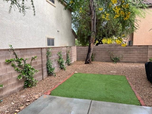 view of yard with a fenced backyard