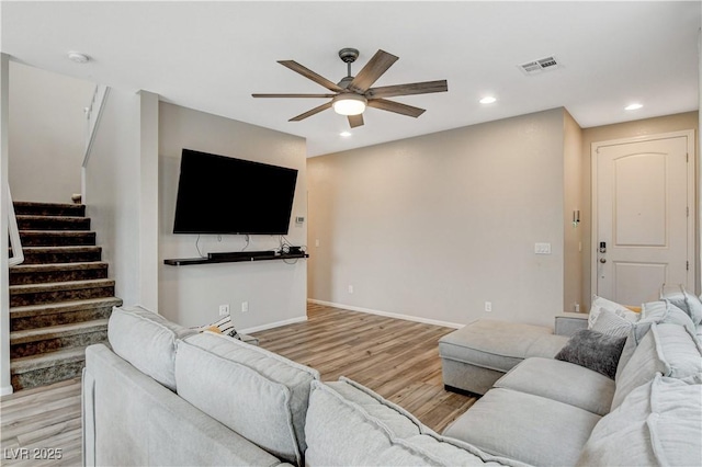 living room with visible vents, ceiling fan, stairway, recessed lighting, and light wood-type flooring