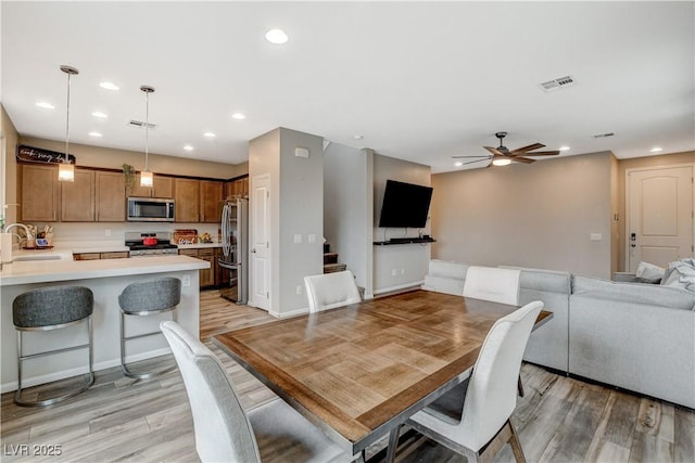 dining room featuring recessed lighting, ceiling fan, visible vents, and light wood-type flooring