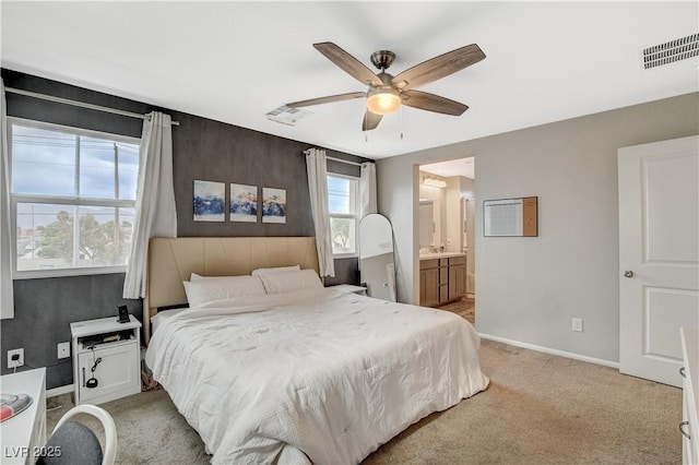 bedroom with light colored carpet, baseboards, visible vents, and ceiling fan