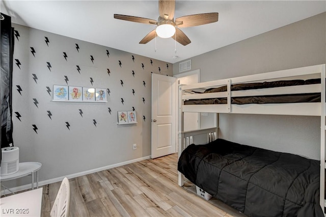 bedroom with visible vents, a ceiling fan, light wood-style floors, and baseboards