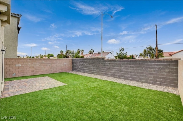 view of yard featuring a patio and a fenced backyard