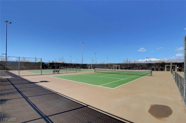 view of tennis court with fence