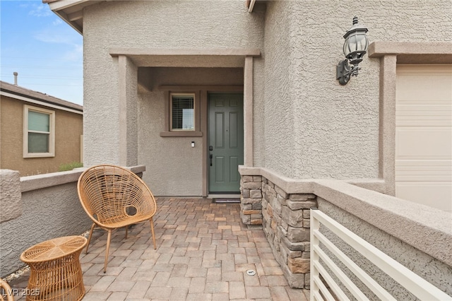 entrance to property featuring stucco siding