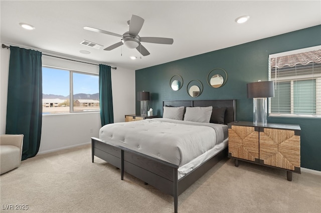 bedroom featuring baseboards, light carpet, recessed lighting, and visible vents