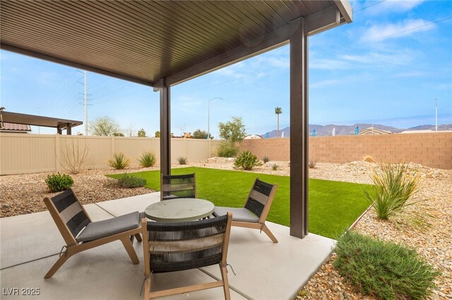 2624 Stanhurst Ave, North Las Vegas, NV 89081 - view of patio with a fenced backyard and a mountain view