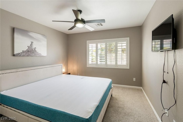 carpeted bedroom featuring baseboards, a ceiling fan, and visible vents
