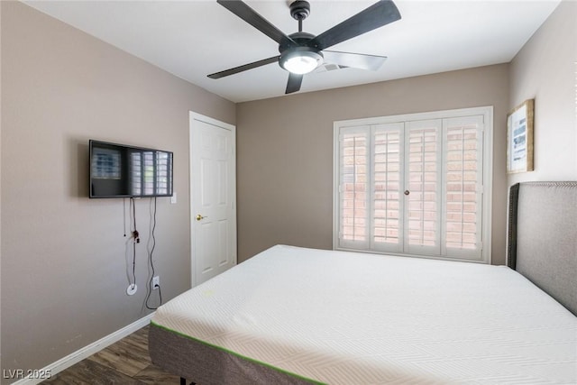 bedroom featuring baseboards, ceiling fan, and wood finished floors