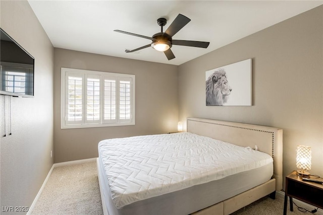 carpeted bedroom featuring baseboards and a ceiling fan