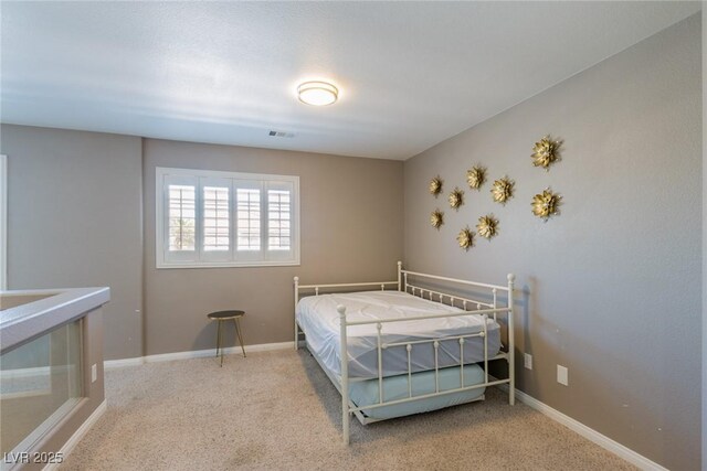 carpeted bedroom featuring baseboards and visible vents