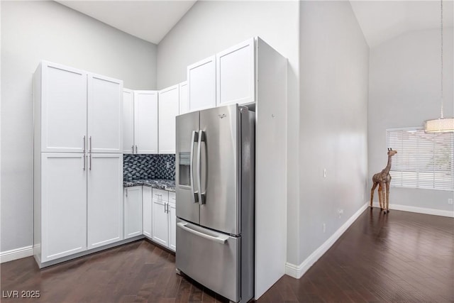 1084 Little House Ct, Henderson, NV 89011 - kitchen featuring decorative backsplash, vaulted ceiling, stainless steel fridge with ice dispenser, baseboards, and dark wood-style floors