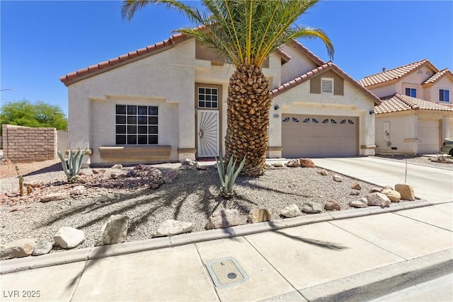 1084 Little House Ct, Henderson, NV 89011 - mediterranean / spanish house with stucco siding, a tiled roof, concrete driveway, and a garage