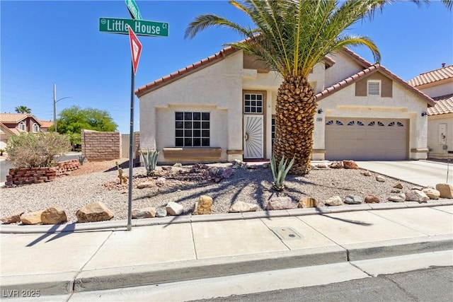 1084 Little House Ct, Henderson, NV 89011 - view of front facade featuring concrete driveway, stucco siding, an attached garage, and a tiled roof