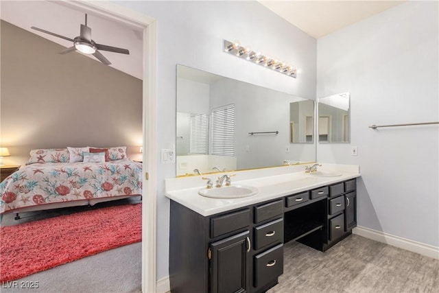 1084 Little House Ct, Henderson, NV 89011 - ensuite bathroom with double vanity, ceiling fan, a sink, baseboards, and connected bathroom