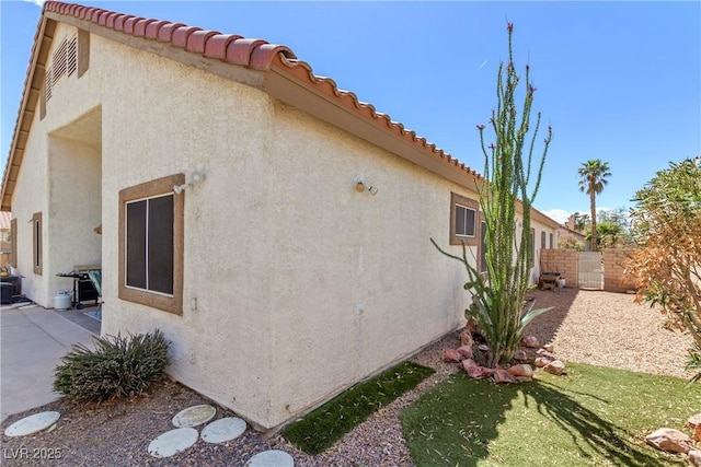 1084 Little House Ct, Henderson, NV 89011 - view of property exterior featuring a tiled roof, fence, and stucco siding