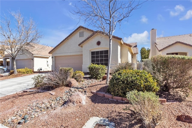 view of front of house featuring a tiled roof, driveway, a chimney, a garage, and stucco siding