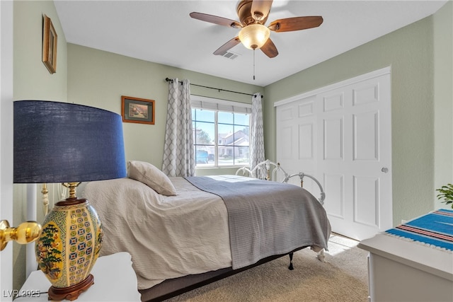 bedroom featuring a ceiling fan, carpet, a closet, and visible vents