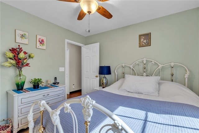 bedroom featuring dark wood-type flooring and ceiling fan