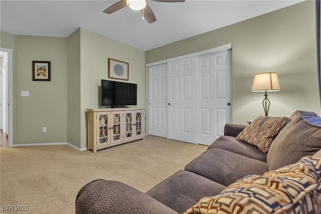 living area with carpet floors, a ceiling fan, and baseboards