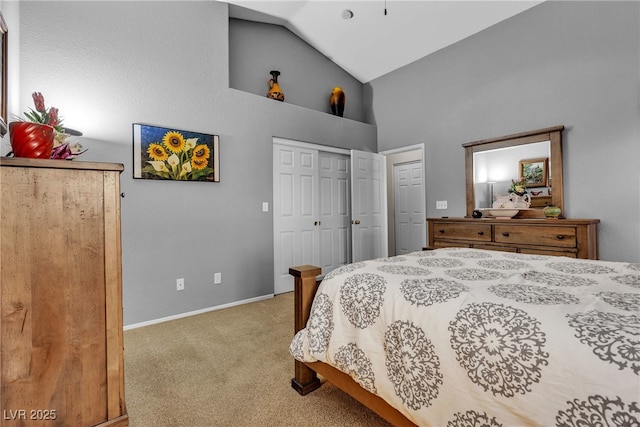 carpeted bedroom with baseboards and high vaulted ceiling