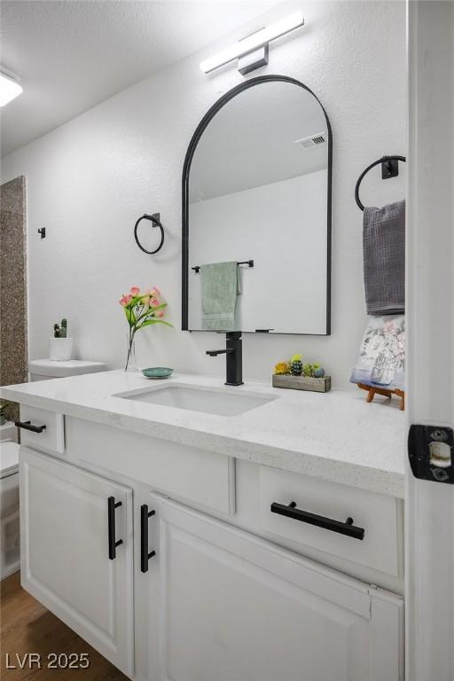 4980 Indian River Dr Unit 447, Las Vegas, NV 89103 - bathroom featuring toilet, vanity, and wood finished floors