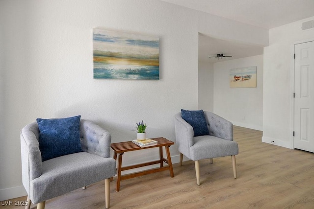 4980 Indian River Dr Unit 447, Las Vegas, NV 89103 - living area featuring baseboards, visible vents, and wood finished floors