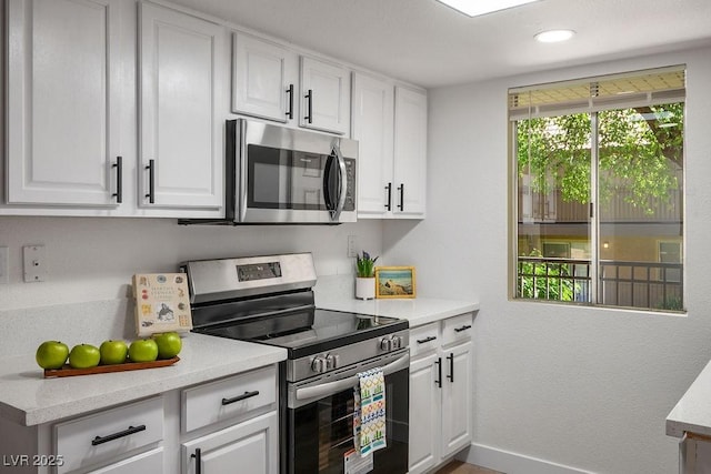 4980 Indian River Dr Unit 447, Las Vegas, NV 89103 - kitchen featuring white cabinets, baseboards, light countertops, appliances with stainless steel finishes, and recessed lighting
