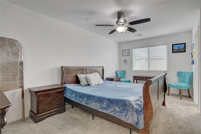 carpeted bedroom with baseboards, a ceiling fan, and visible vents