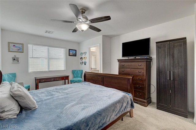 bedroom featuring visible vents, a ceiling fan, baseboards, and light colored carpet