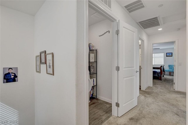 hall featuring recessed lighting, baseboards, and visible vents