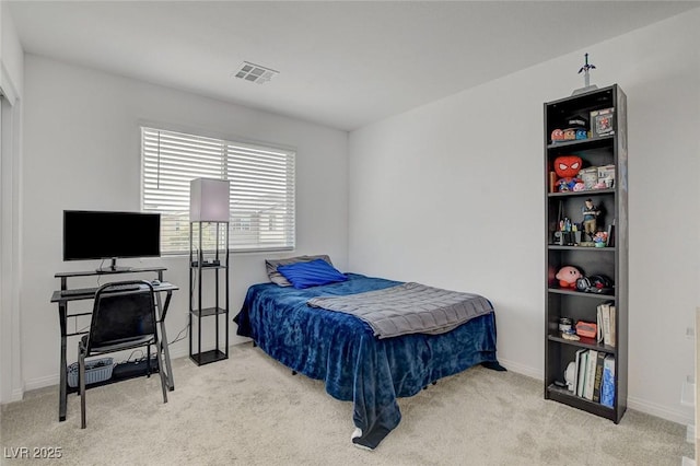 bedroom with baseboards, visible vents, and carpet