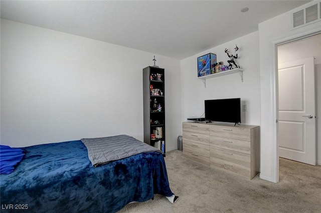 bedroom with baseboards, visible vents, and light carpet