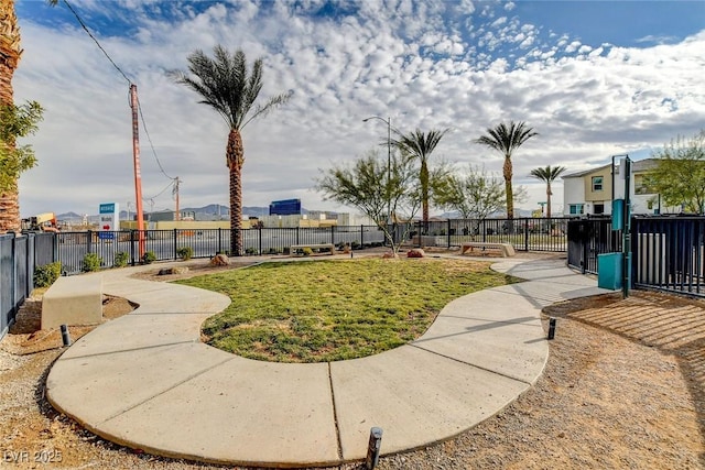 view of property's community featuring a yard and fence