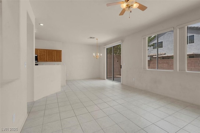 unfurnished room featuring light tile patterned floors, ceiling fan with notable chandelier, recessed lighting, and visible vents