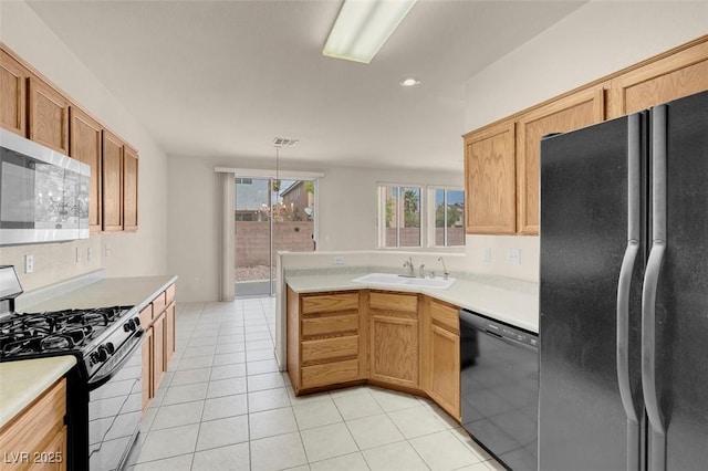kitchen featuring a sink, light countertops, light tile patterned floors, visible vents, and black appliances