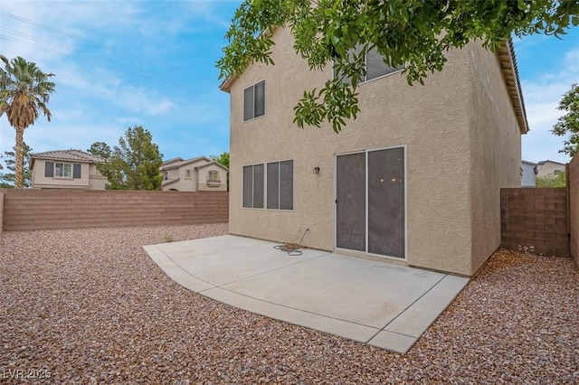 back of house with a patio, a fenced backyard, and stucco siding