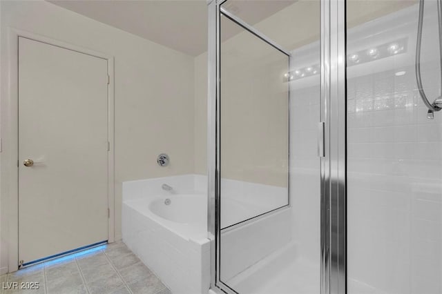 bathroom featuring a garden tub, tile patterned floors, and a stall shower
