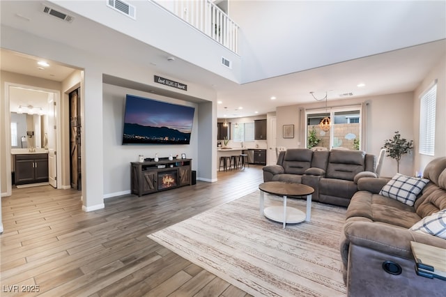 356 Silva Pl, Henderson, NV 89011 - living room featuring visible vents, baseboards, and light wood-type flooring