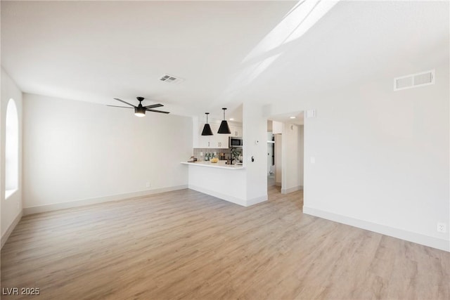 unfurnished living room featuring baseboards, ceiling fan, visible vents, and light wood-style flooring