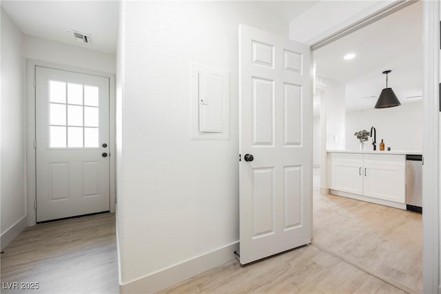 hallway with visible vents, recessed lighting, light wood finished floors, and baseboards