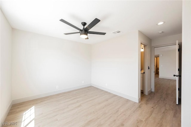 unfurnished room featuring baseboards, ceiling fan, light wood-type flooring, and visible vents