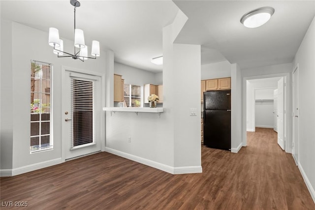 kitchen with freestanding refrigerator, a chandelier, light brown cabinets, and dark wood-style floors