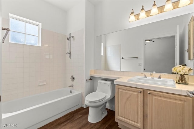 full bath featuring vanity, toilet, bathtub / shower combination, and wood finished floors