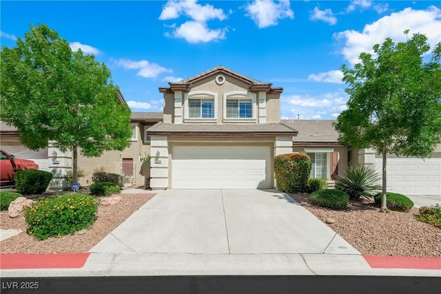 view of front of home with a garage, stucco siding, and concrete driveway