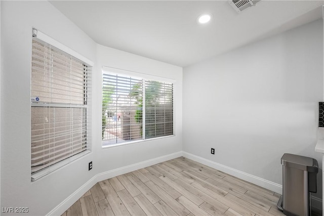 unfurnished room featuring visible vents, recessed lighting, light wood-style floors, and baseboards