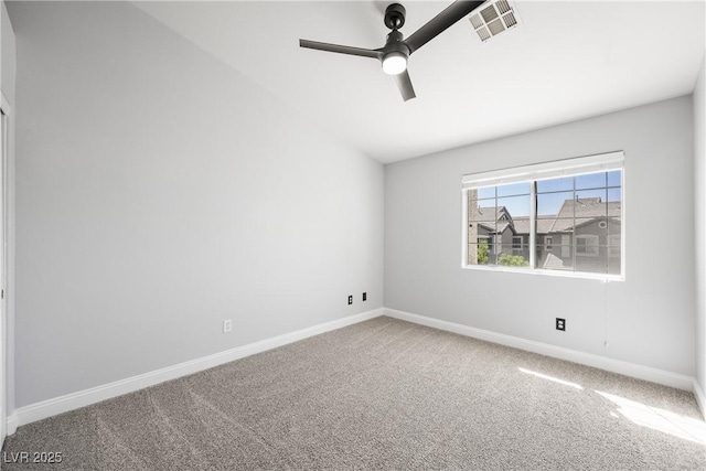 empty room with carpet floors, ceiling fan, visible vents, and baseboards
