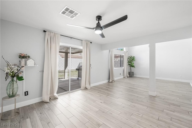 interior space featuring visible vents, a ceiling fan, plenty of natural light, and light wood-type flooring