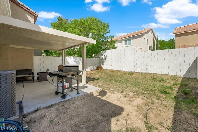 view of yard featuring a fenced backyard, cooling unit, and a patio area